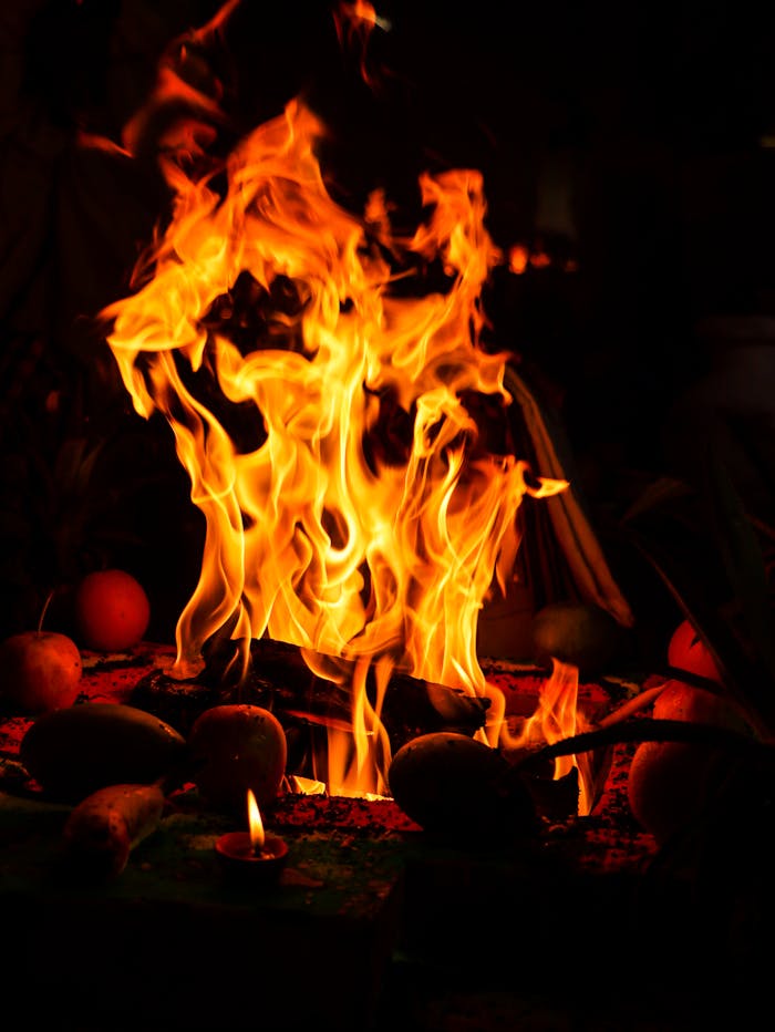 gallery-6 A dramatic depiction of a ritual fire at night with vivid orange flames.