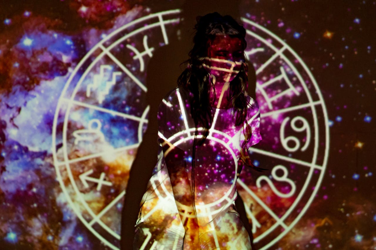 services-02 A mystical image of a woman enveloped in celestial projections and astrological symbols.